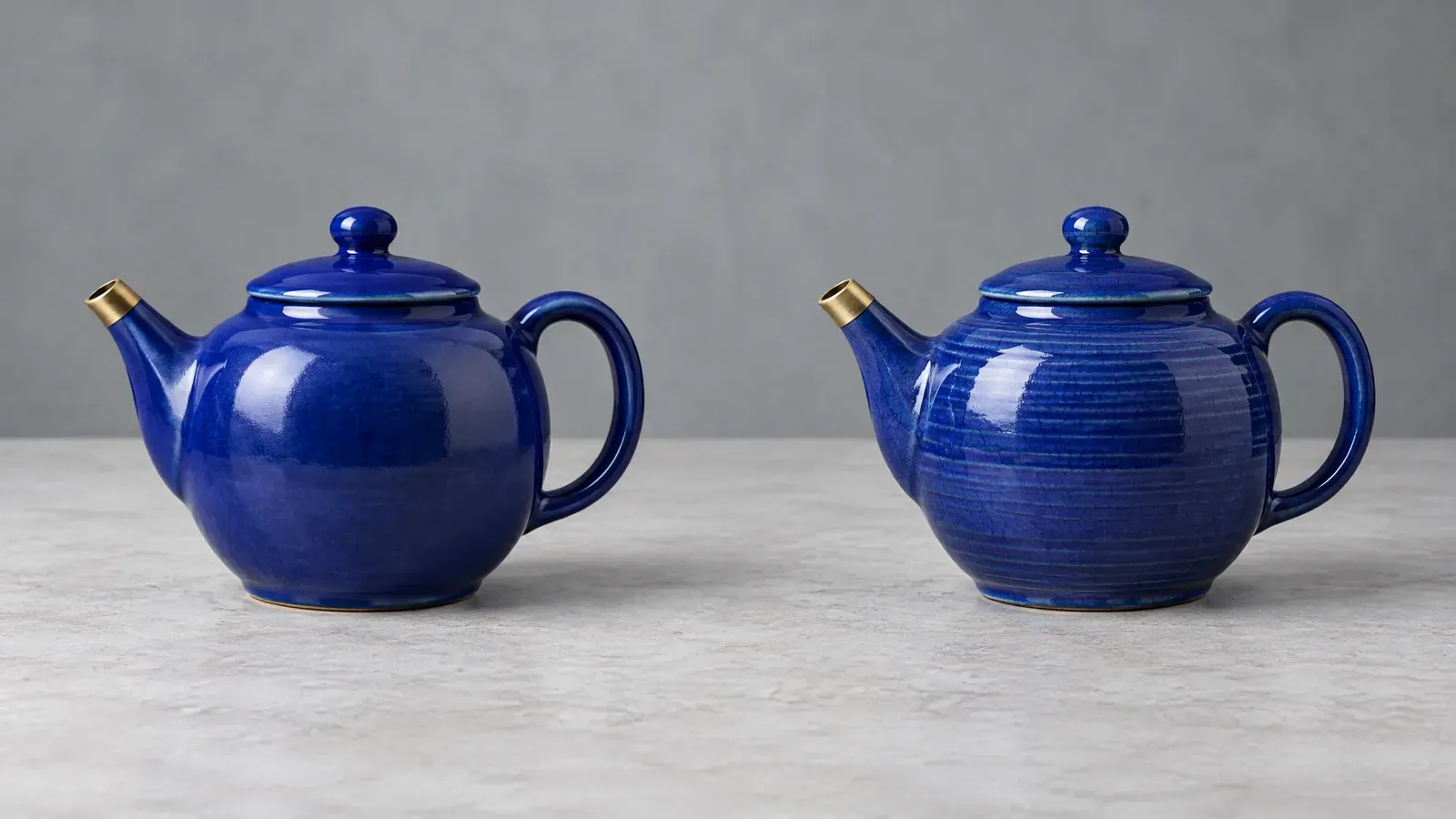 Two identical cobalt teapots on a pale worktop, one lit for speed and one for scrutiny